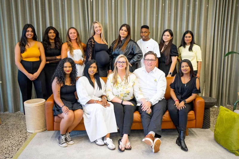 FabMags team group photo seated on leather couch