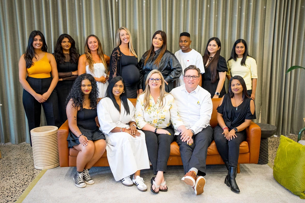 FabMags team group photo seated on leather couch