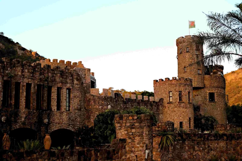Stone castle with turrets and battlements against a hillside
